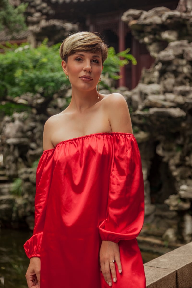 Beautiful young woman in red dress in Yuyuan Garden, Shanghai, China