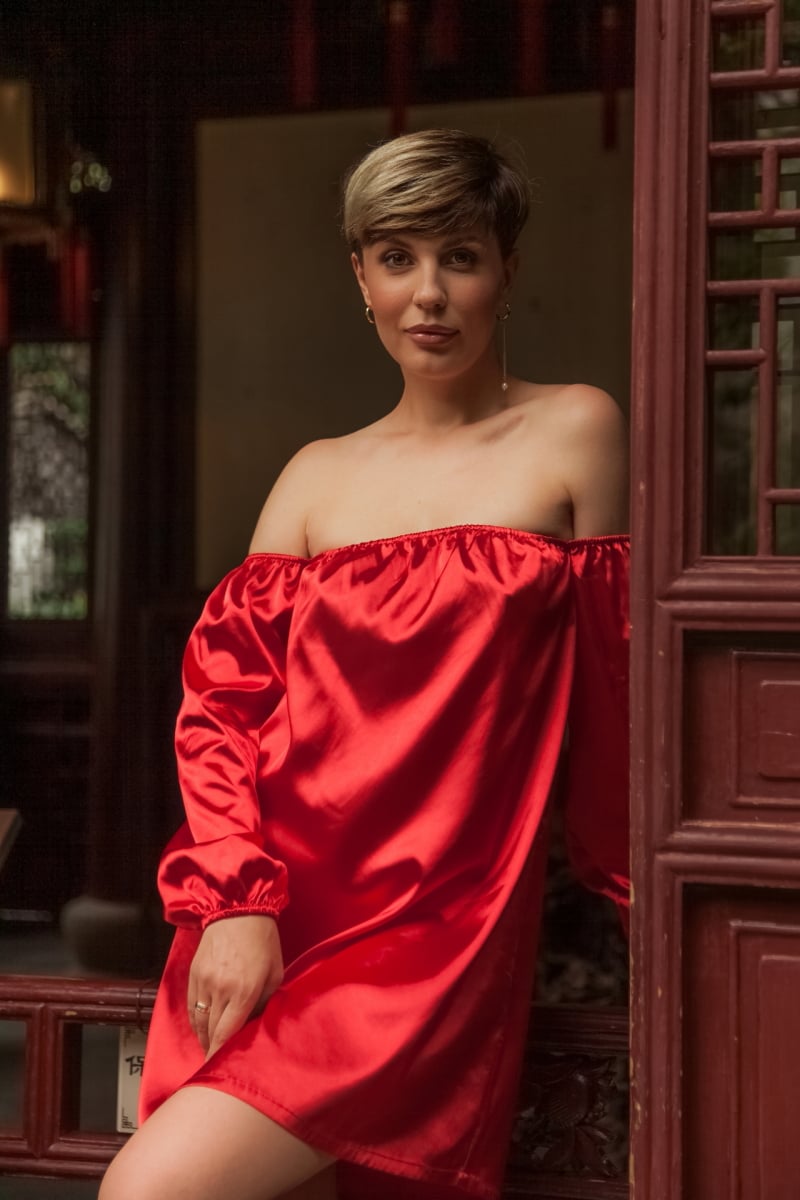 Beautiful young woman in red dress in Yuyuan Garden, Shanghai, China