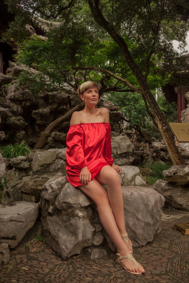 Beautiful young woman in red dress in Yuyuan Garden, Shanghai, China