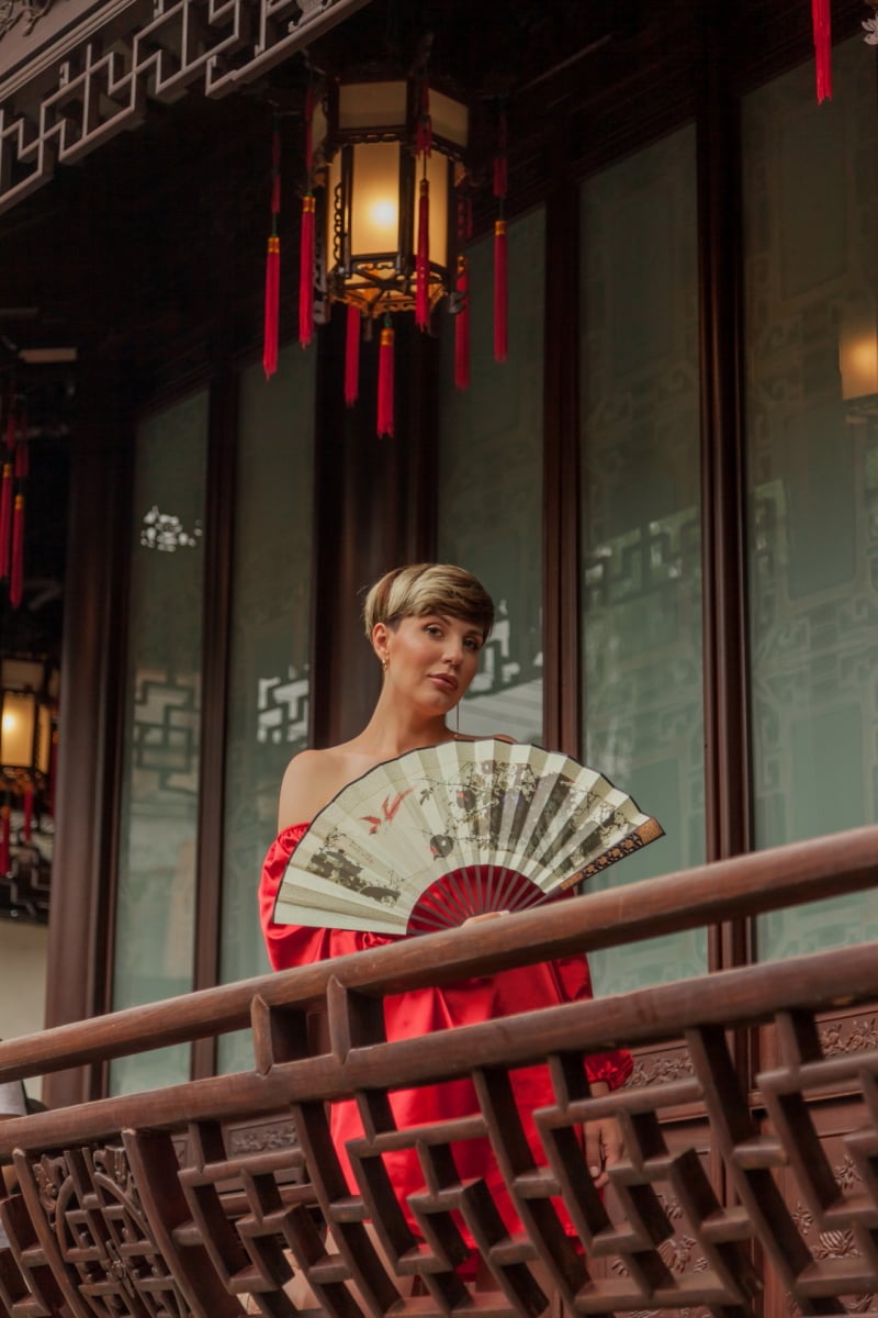 Beautiful young woman in red dress in Yuyuan Garden, Shanghai, China