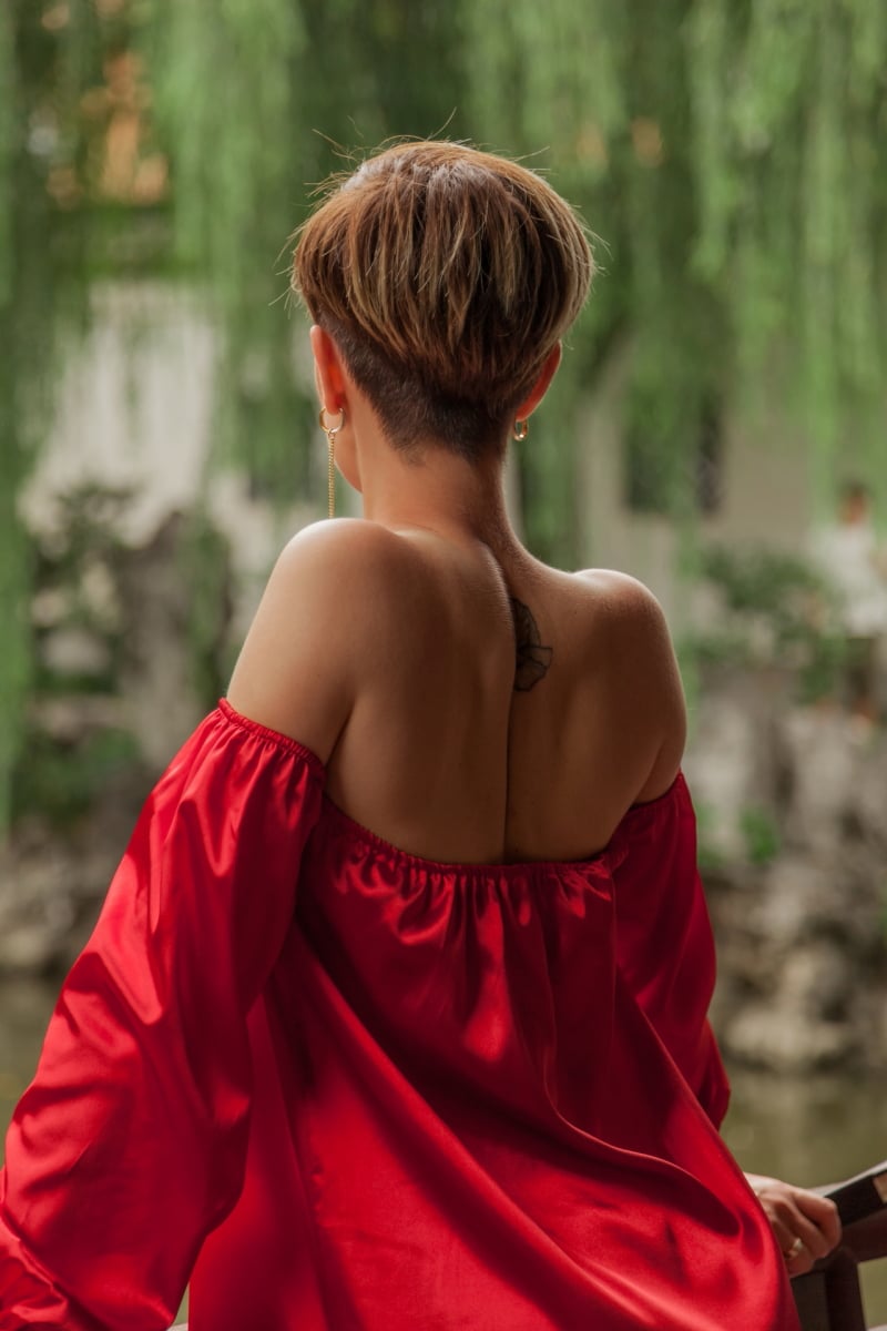 Beautiful young woman in red dress in Yuyuan Garden, Shanghai, China