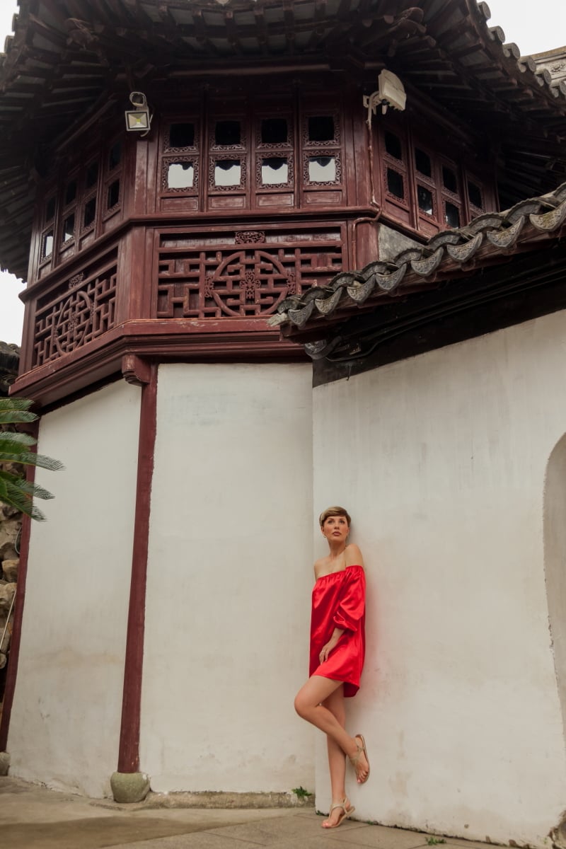 Beautiful young woman in red dress in Yuyuan Garden, Shanghai, China