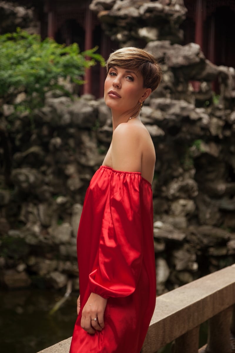 Beautiful young woman in red dress in Yuyuan Garden, Shanghai, China