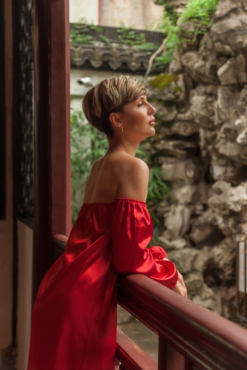 Beautiful young woman in red dress in Yuyuan Garden, Shanghai, China