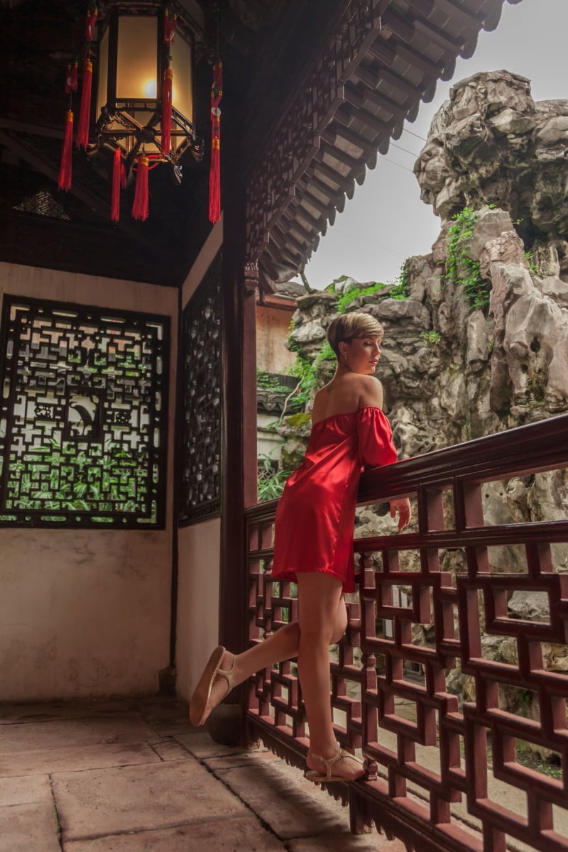 Beautiful young woman in red dress in Yuyuan Garden, Shanghai, China