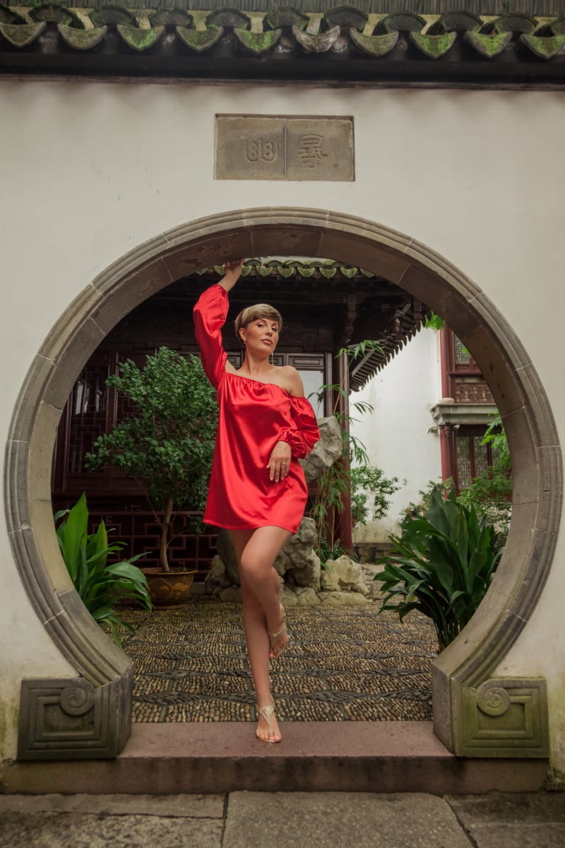 Beautiful young woman in red dress in Yuyuan Garden, Shanghai, China