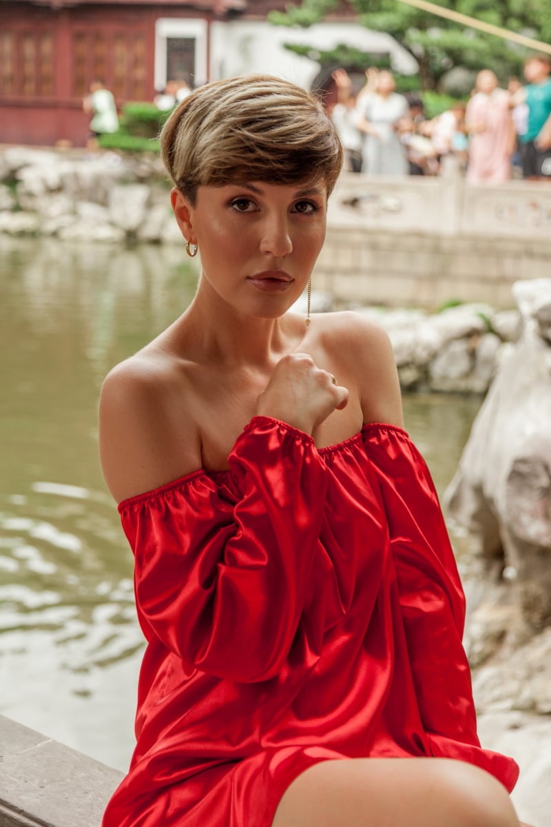 Beautiful young woman in red dress in Yuyuan Garden, Shanghai, China