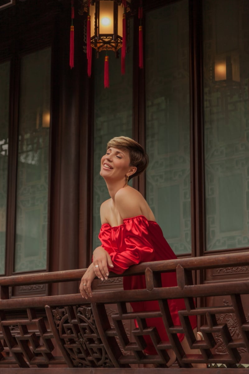 Beautiful young woman in red dress in Yuyuan Garden, Shanghai, China