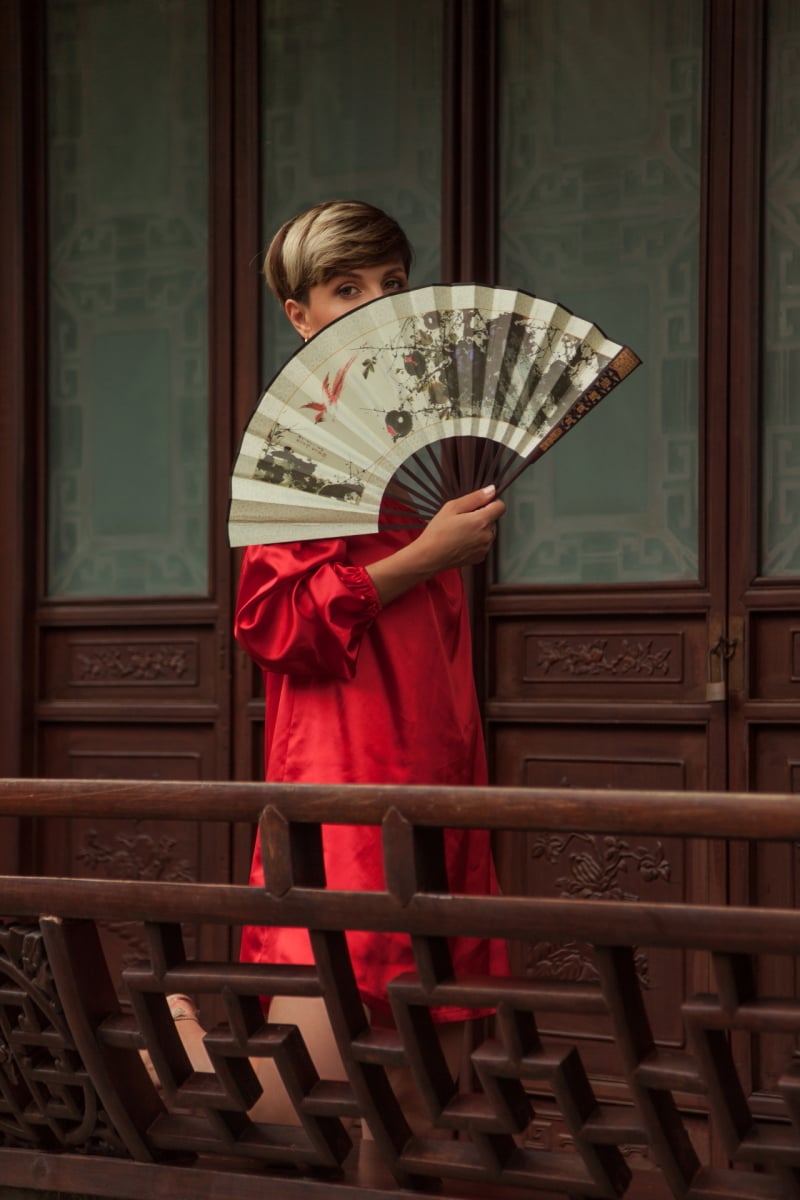 Beautiful young woman in red dress in Yuyuan Garden, Shanghai, China