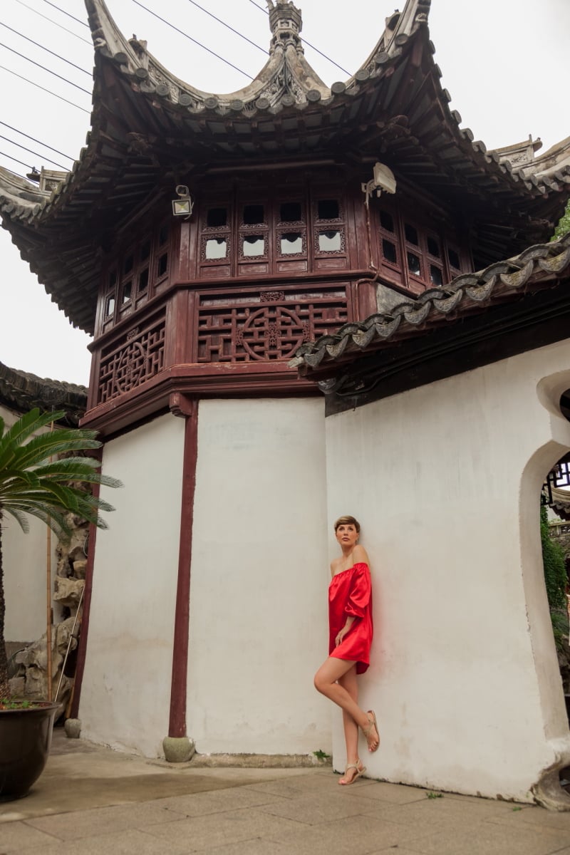 Beautiful young woman in red dress in Yuyuan Garden, Shanghai, China