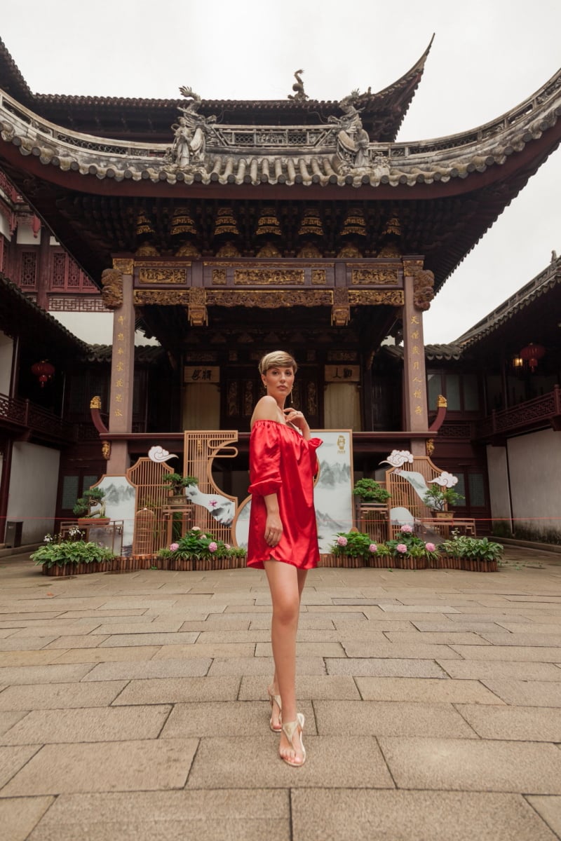 Beautiful young woman in red dress in Yuyuan Garden, Shanghai, China