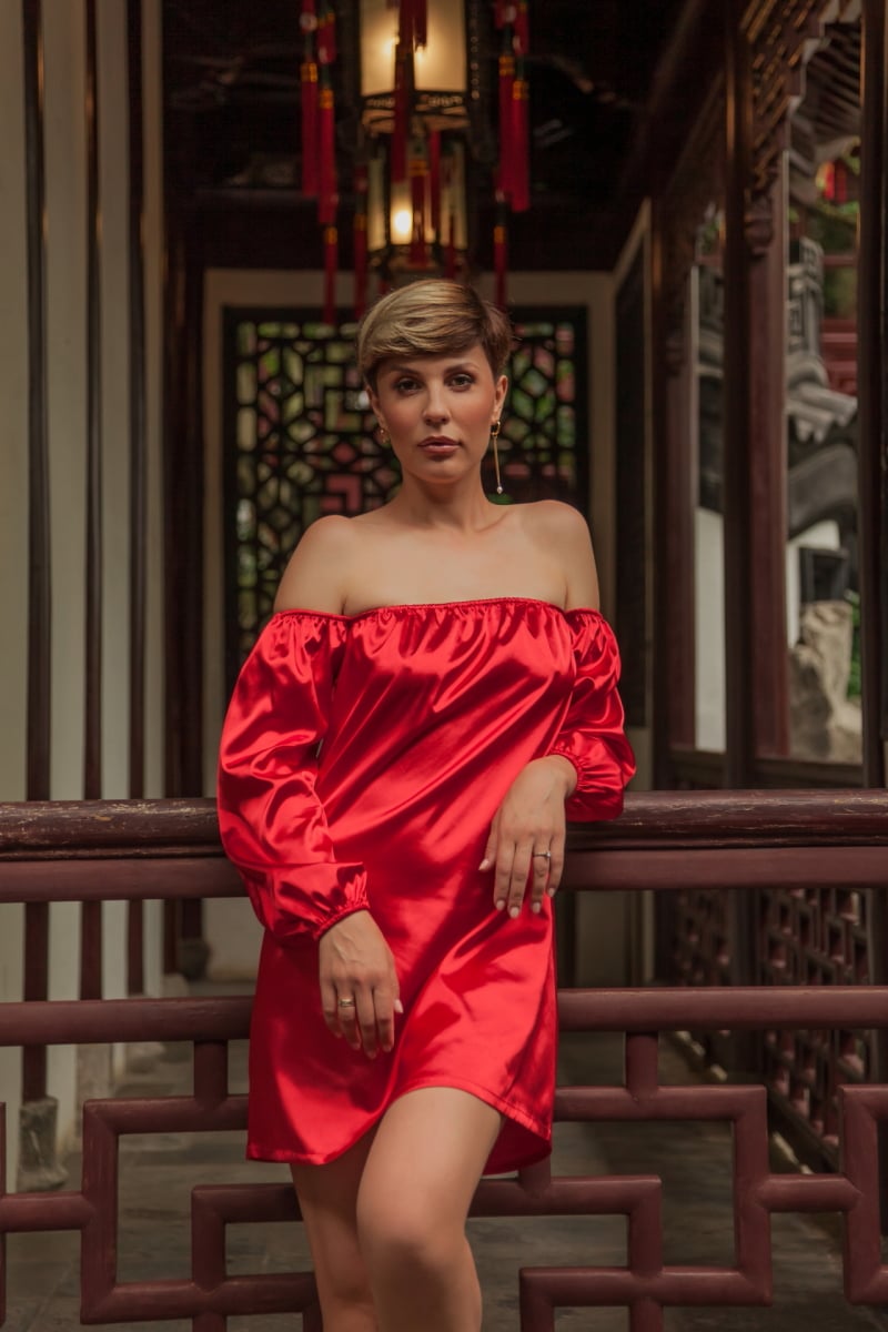 Beautiful young woman in red dress in Yuyuan Garden, Shanghai, China