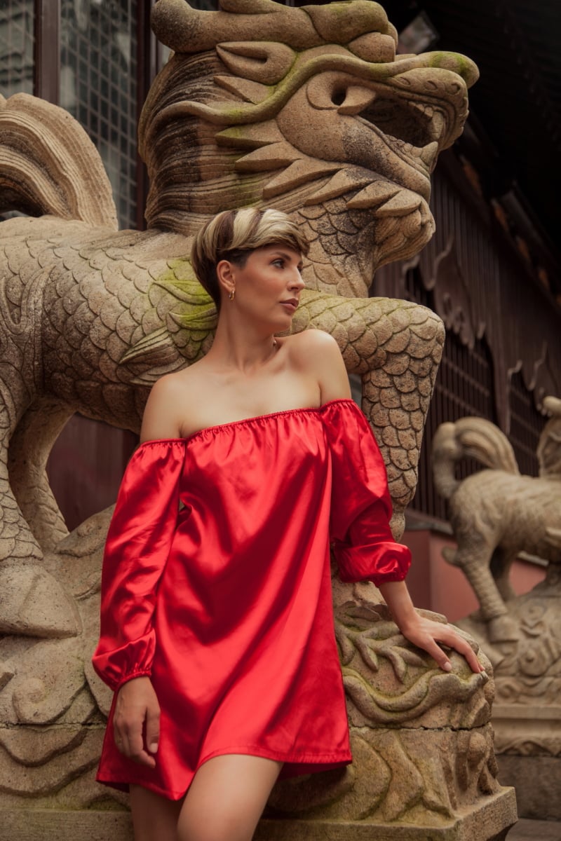 Beautiful young woman in red dress in Yuyuan Garden, Shanghai, China