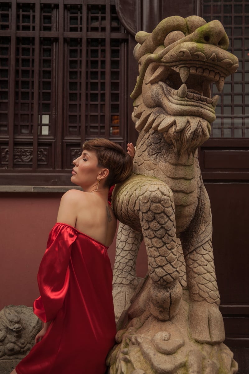 Beautiful young woman in red dress in Yuyuan Garden, Shanghai, China